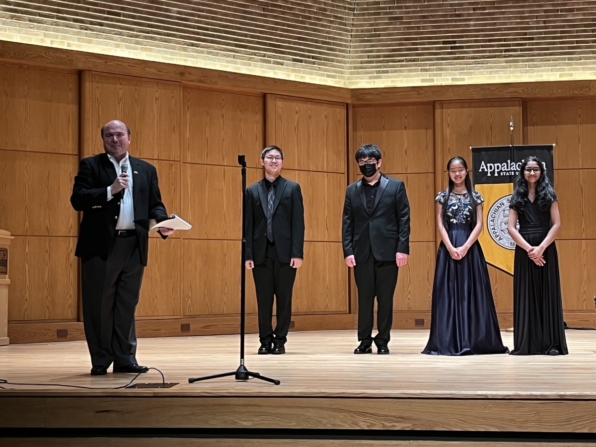 Dean James Douthit introduces the winners of the 2022 piano competition onstage in Rosen Concert Hall.