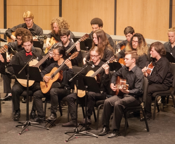 Members of the Appalachian Guitar Orchestra play onstage (pre-COVID photo). 
